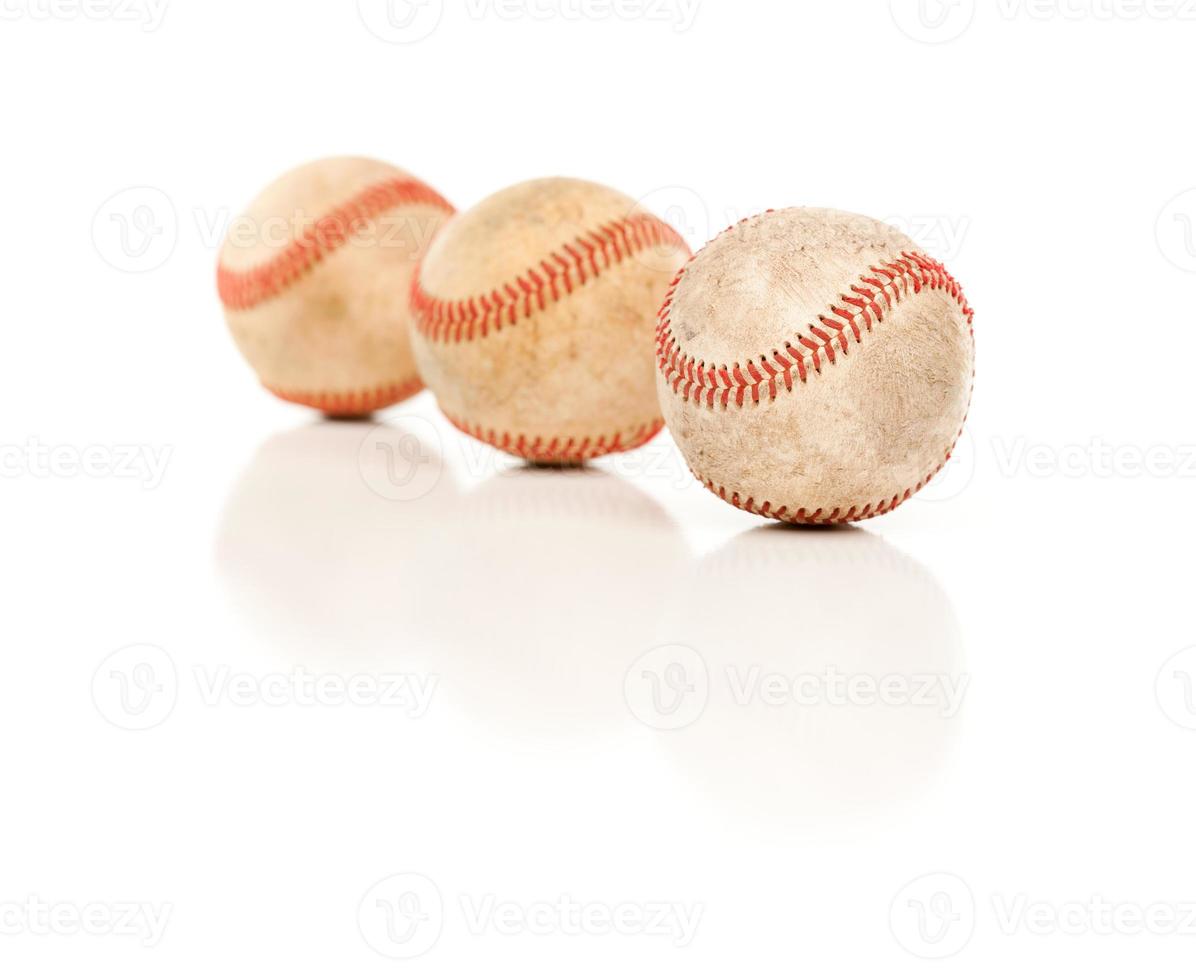 Three Baseballs Isolated on Reflective White photo