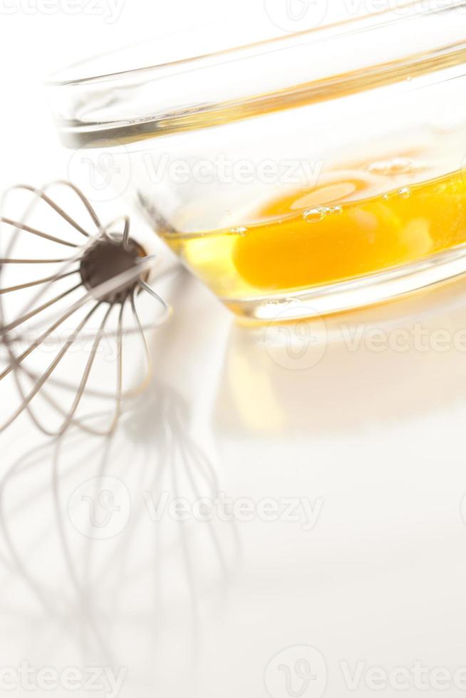 Hand Mixer with Eggs in Glass Bowl photo