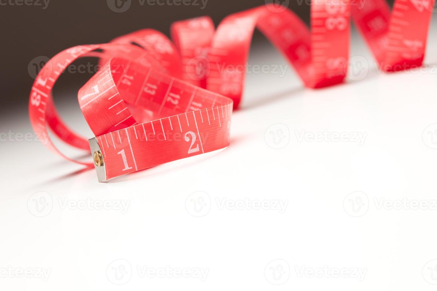 cinta métrica roja sobre fondo degradado foto