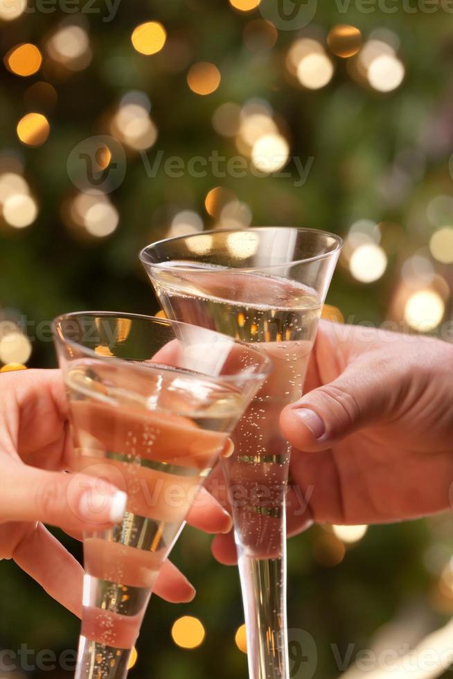 Man and Woman Toasting Champagne in Front of Lights photo