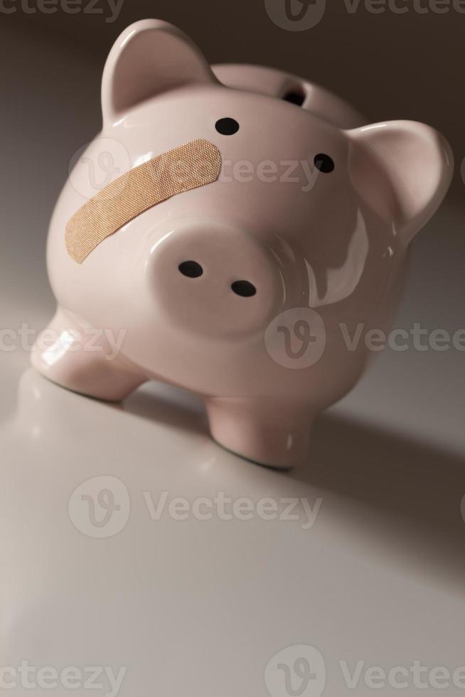 Piggy Bank with Bandage on Face photo