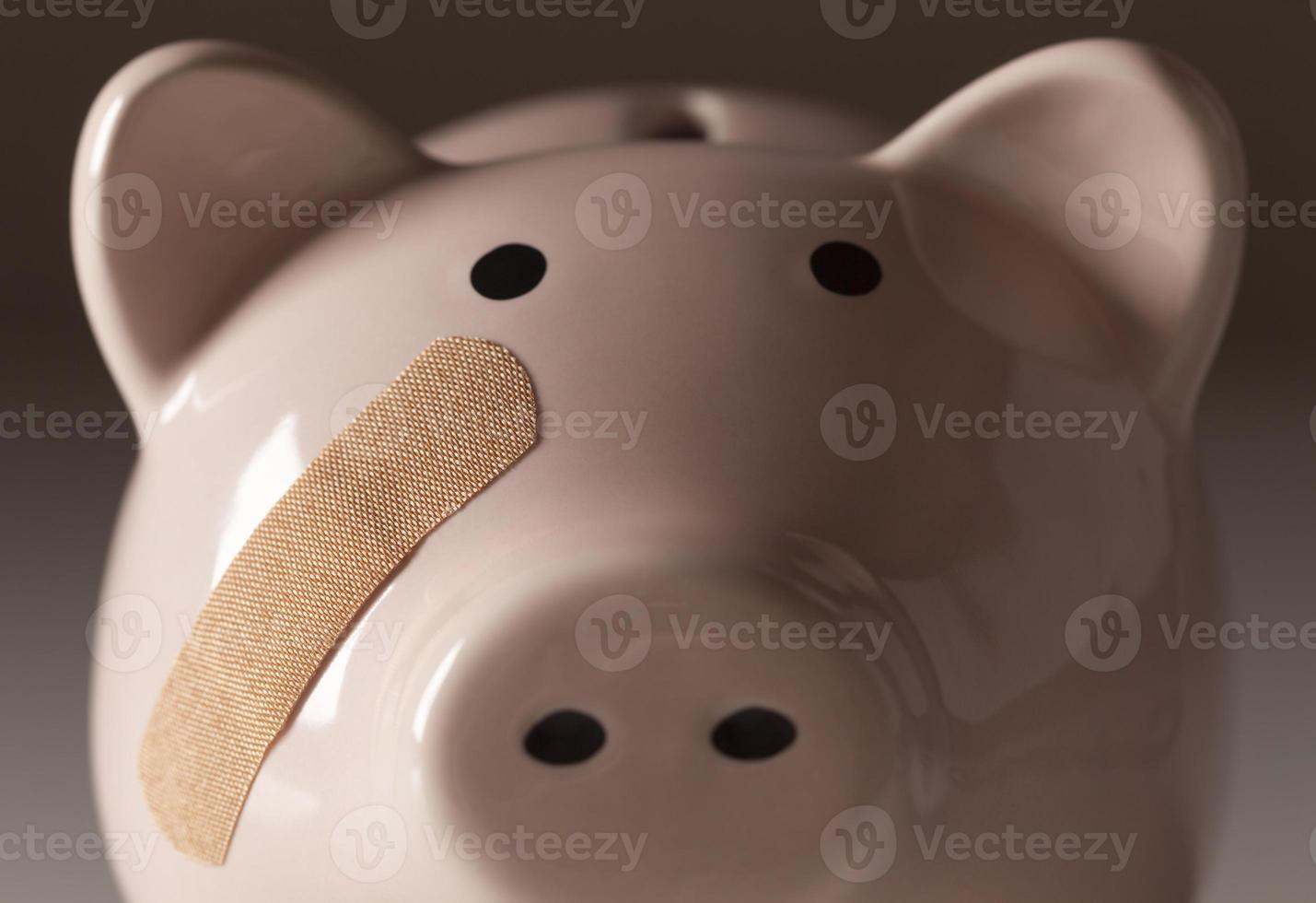 Piggy Bank with Bandage on Face photo