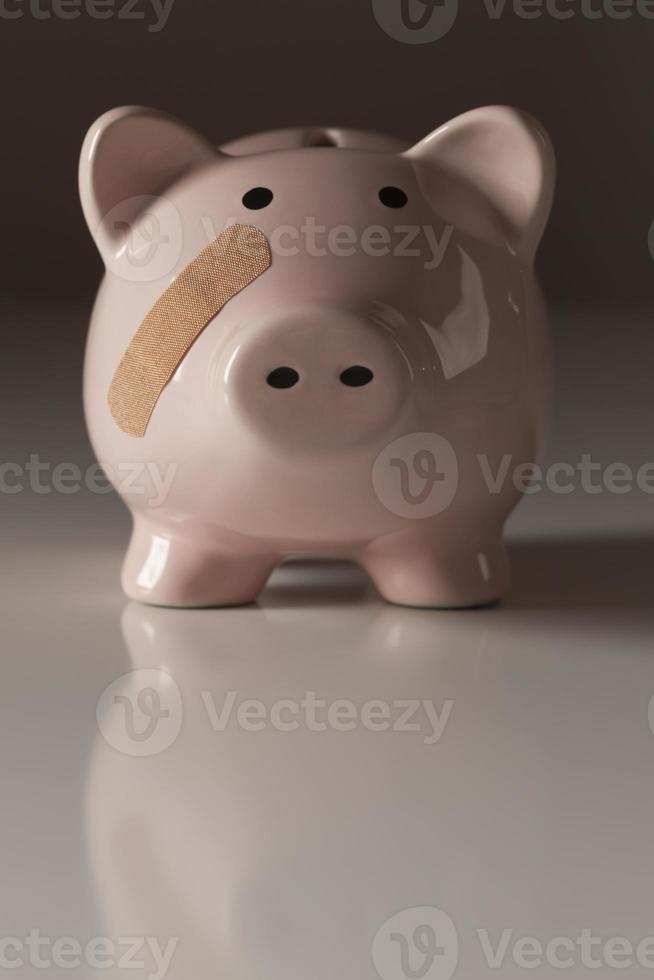 Piggy Bank with Bandage on Face photo