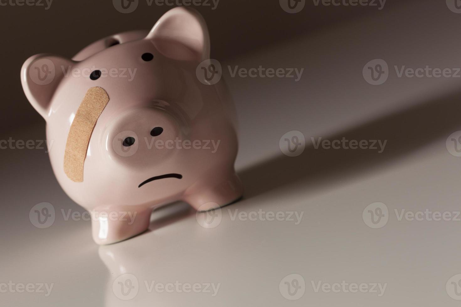 Piggy Bank with Bandage on Face photo