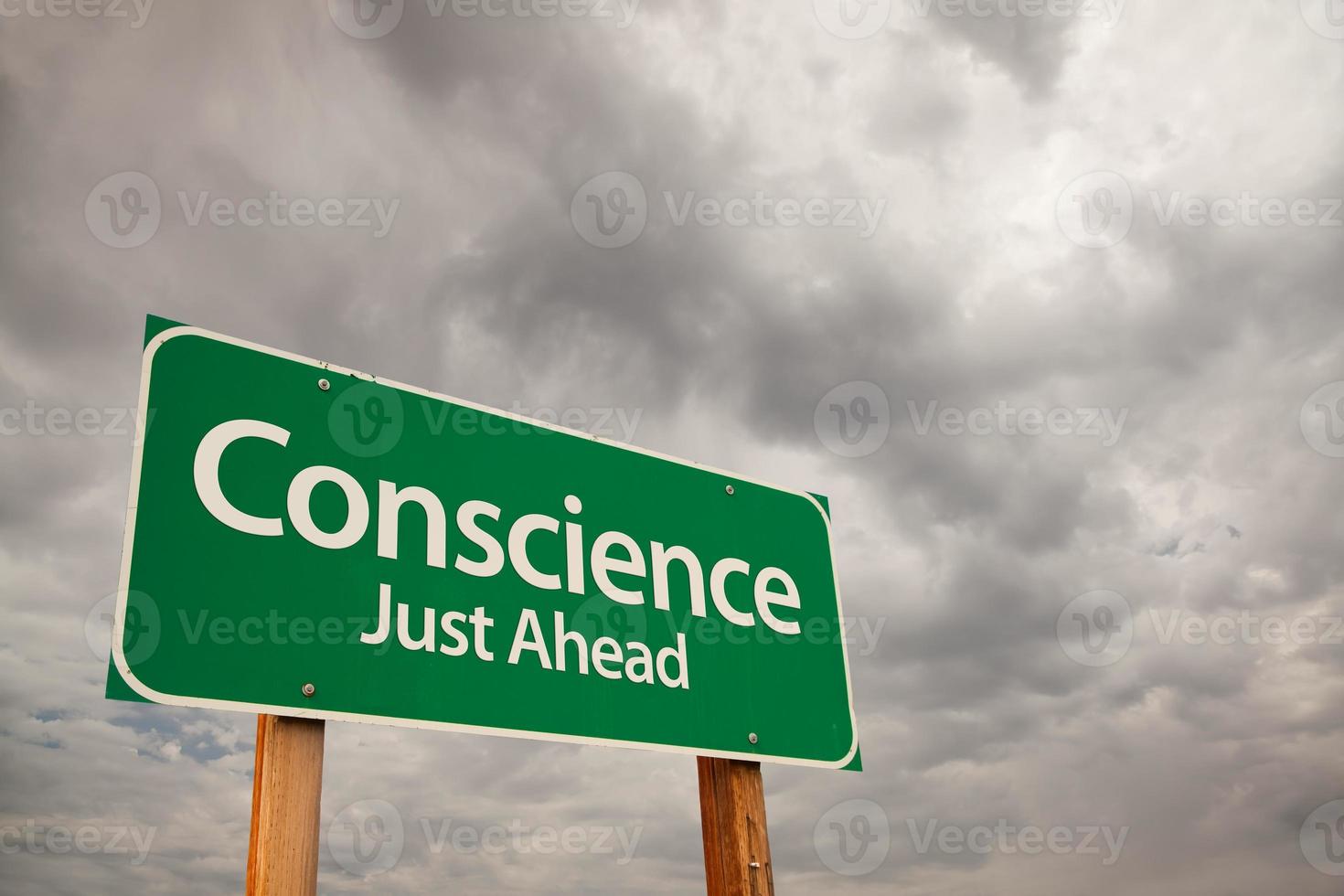Conscience Green Road Sign Over Storm Clouds photo