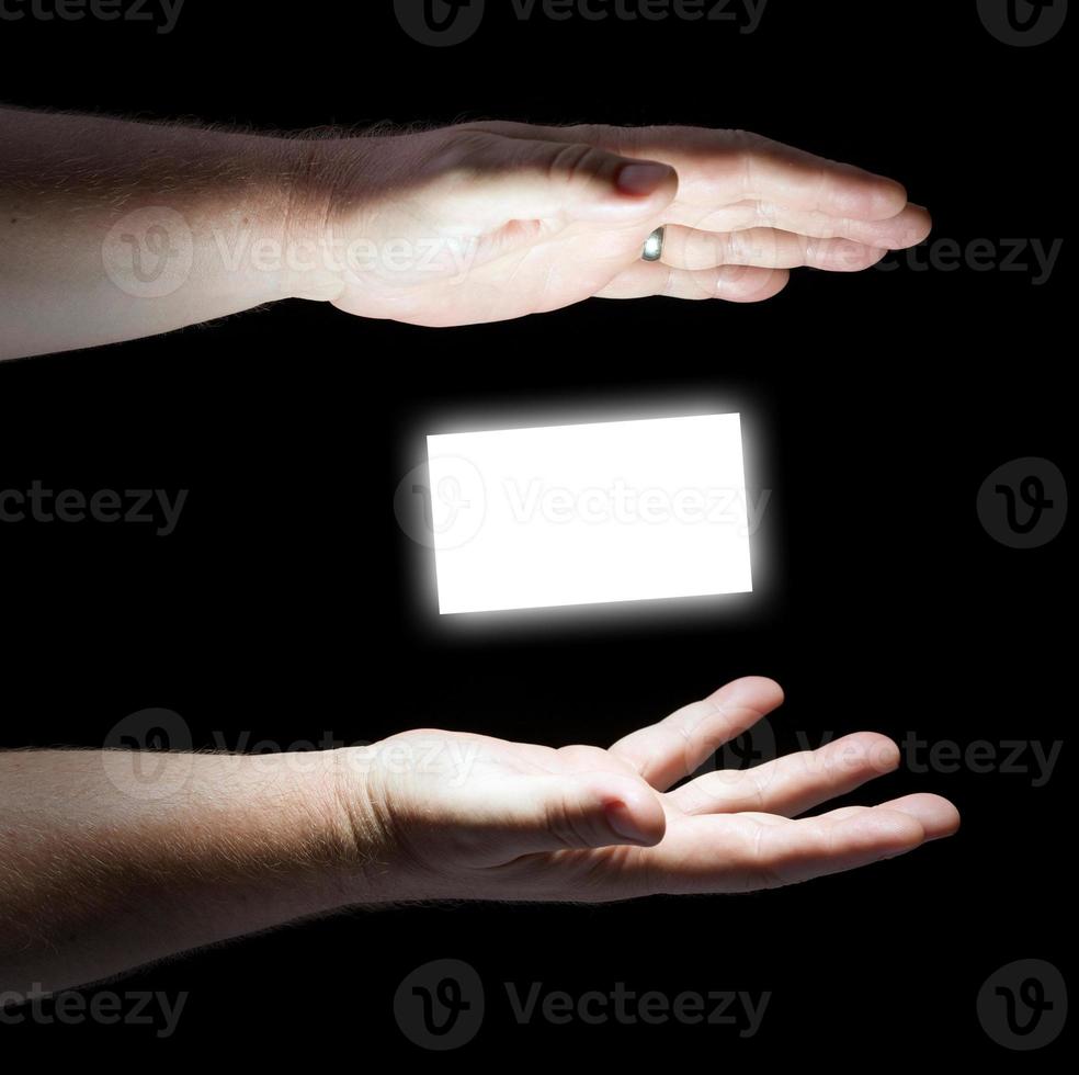 Business Card Floating Between Two Male Hands photo