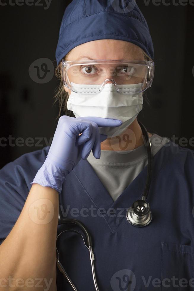 Concerned Female Doctor or Nurse Wearing Protective Facial Wear photo