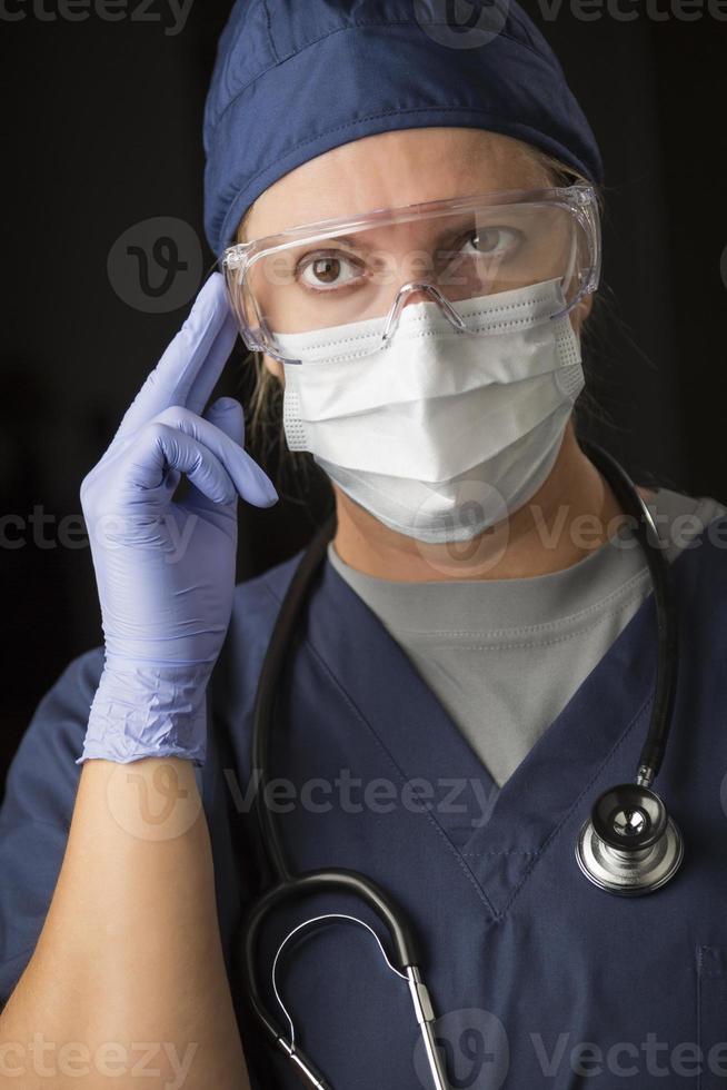 Concerned Female Doctor or Nurse Wearing Protective Facial Wear photo