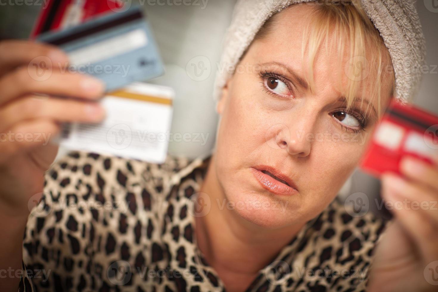 Upset Woman Glaring At Her Many Credit Cards photo