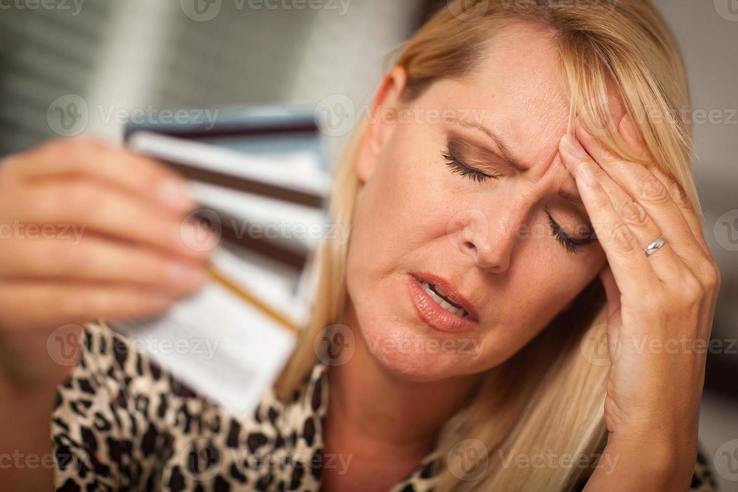 Upset Woman Holding Her Many Credit Cards photo
