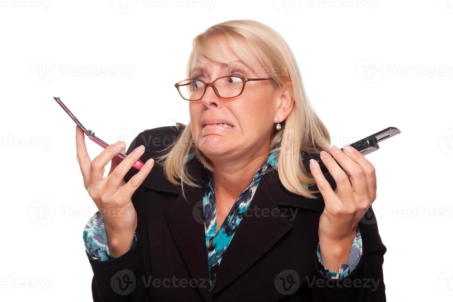 Frustrated Woman with Two Cell Phones photo