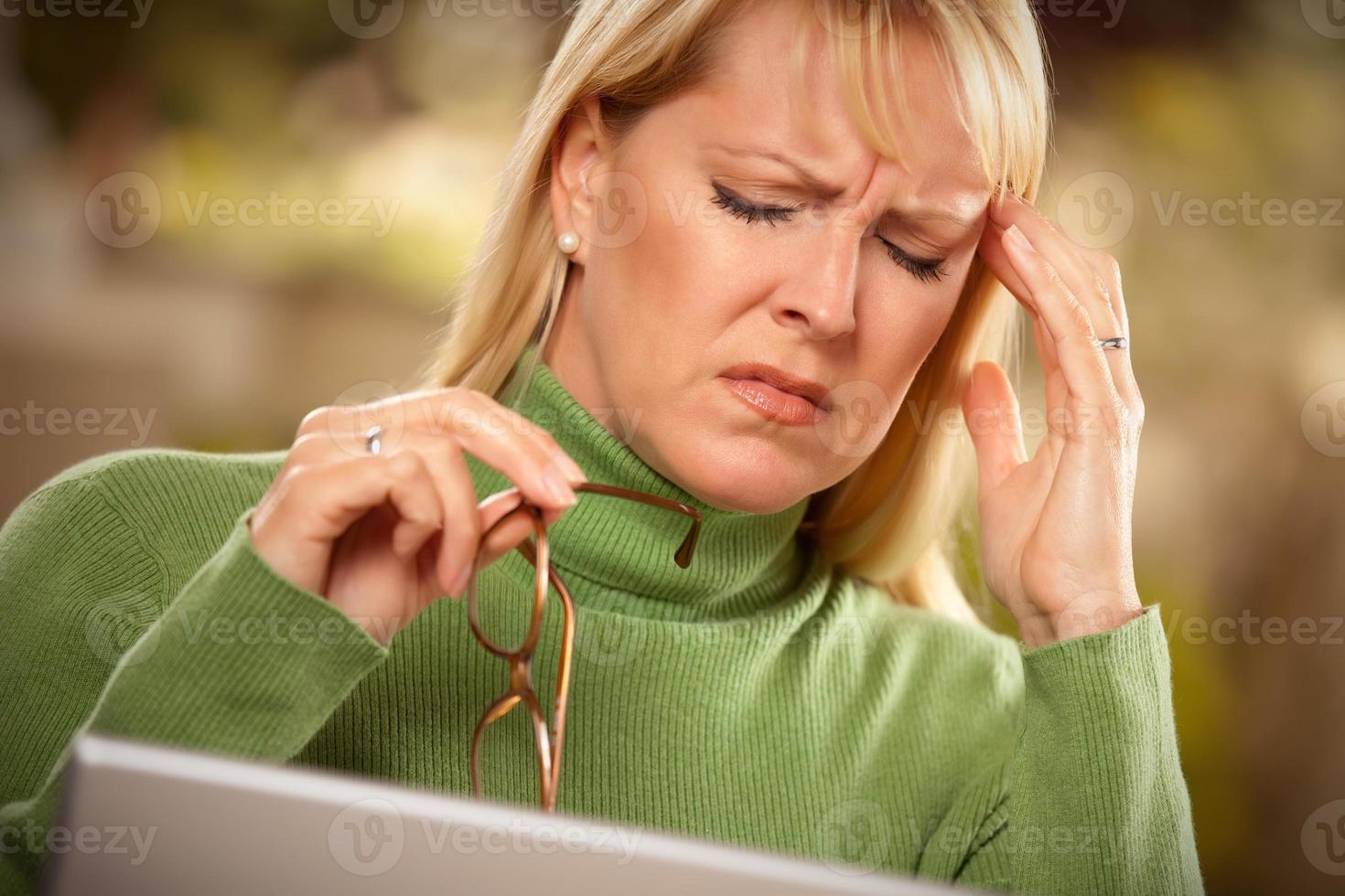 Grimacing Woman Suffering a Headache photo