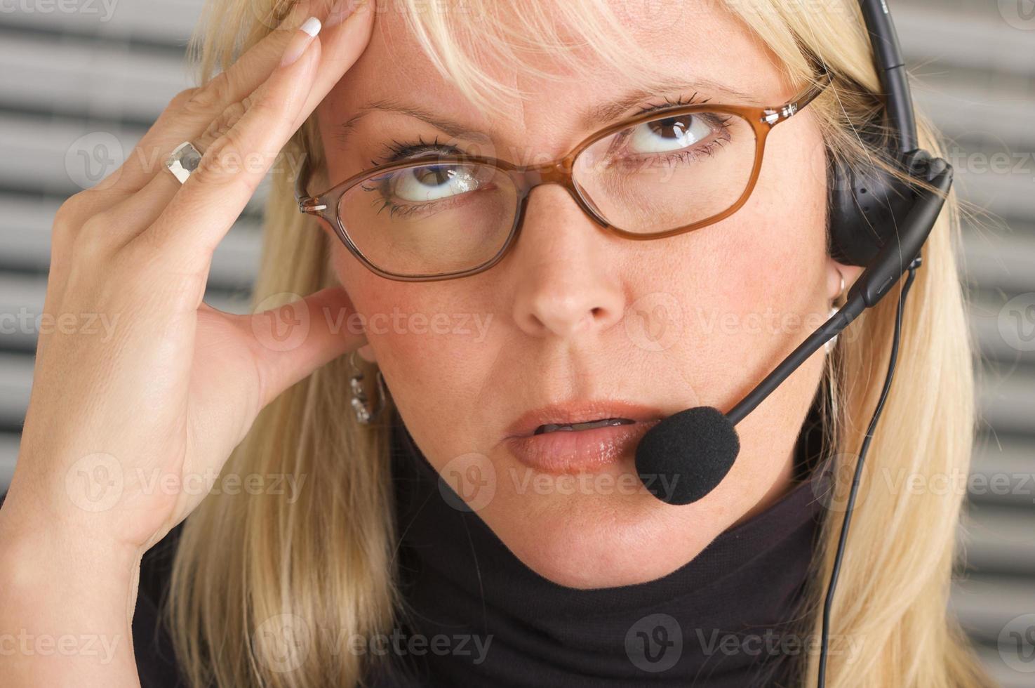 Businesswoman with Phone Headset and Headache photo