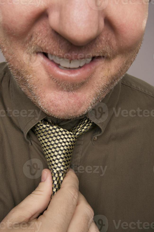 Smiling Man Fixing Tie photo