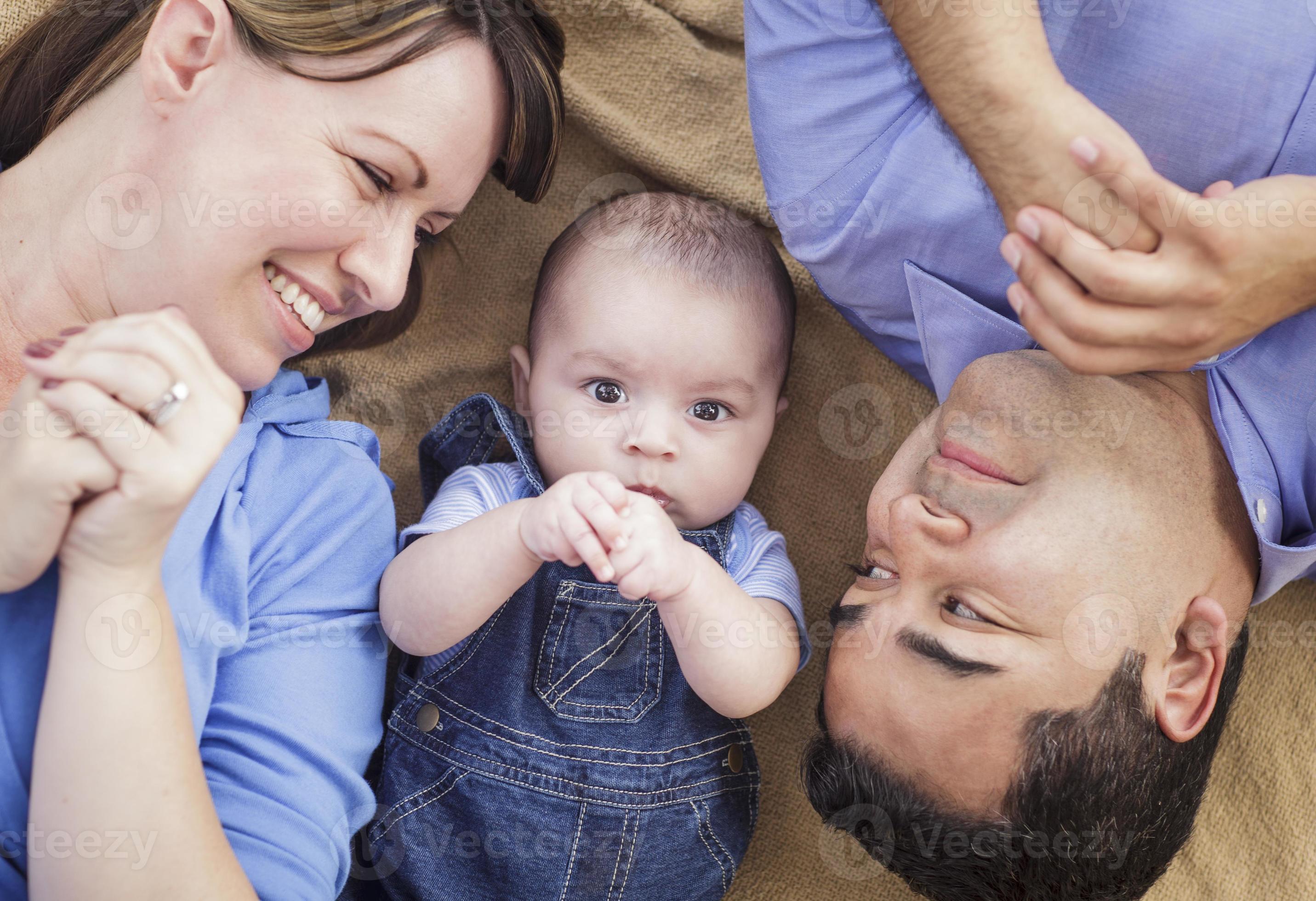 Mixed race family playing on the blanket 16356470 stock photo at vecteezy