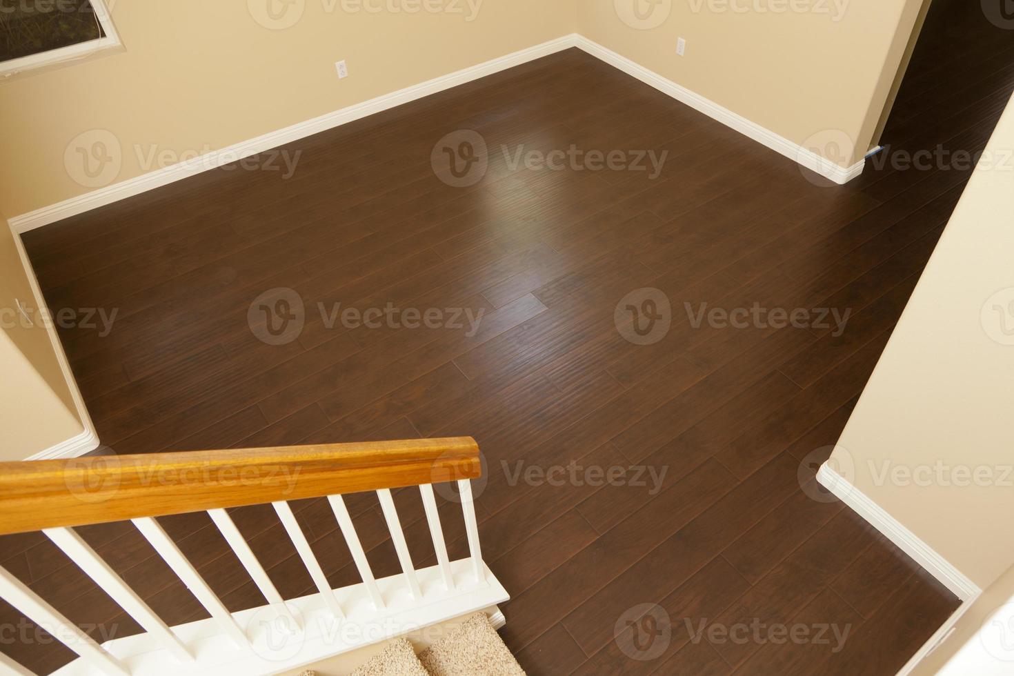 Newly Installed Brown Laminate Flooring and Baseboards in Home photo