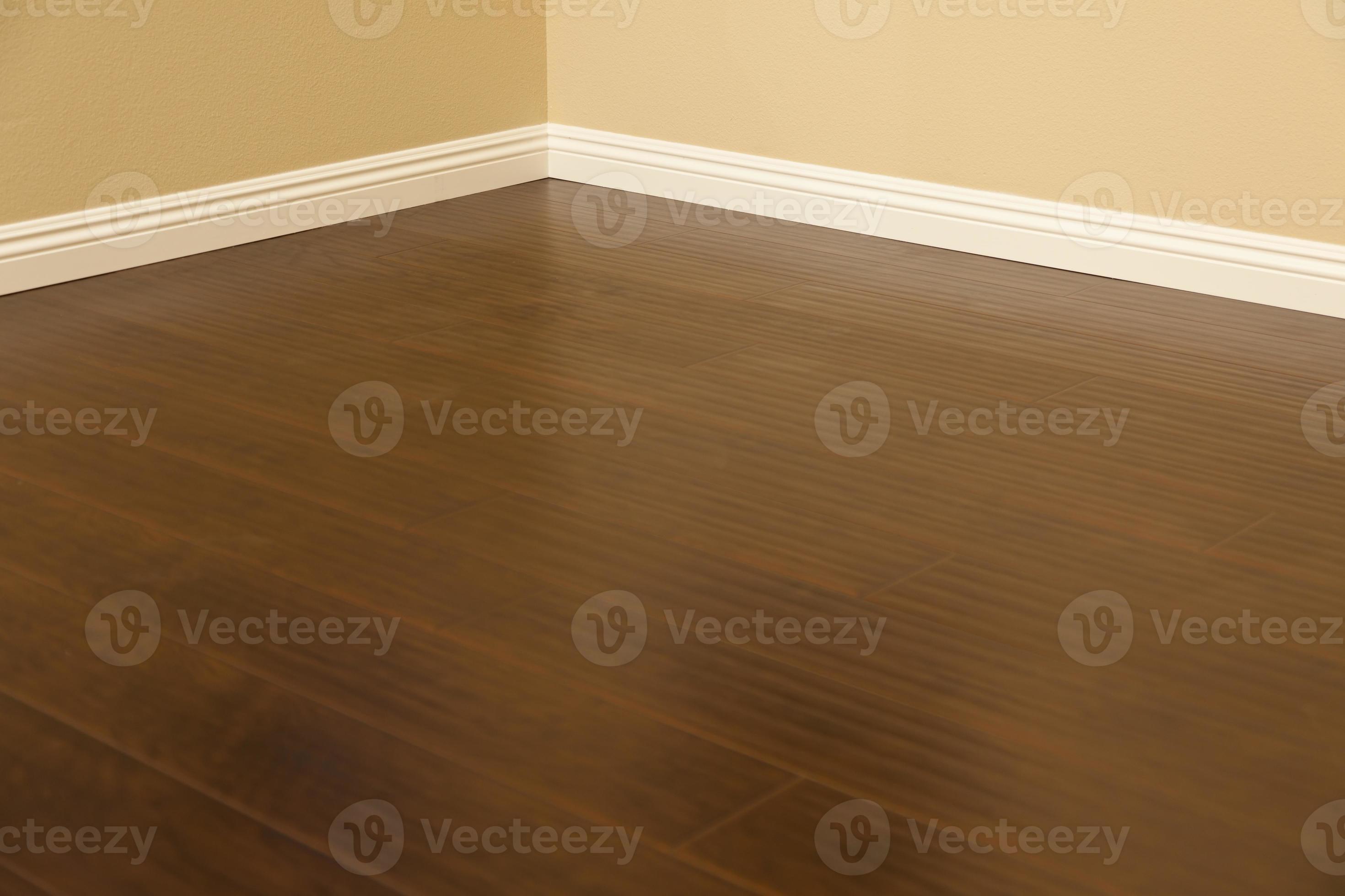 Newly Installed Brown Laminate Flooring and Baseboards in Home 16356560 Stock Photo at Vecteezy