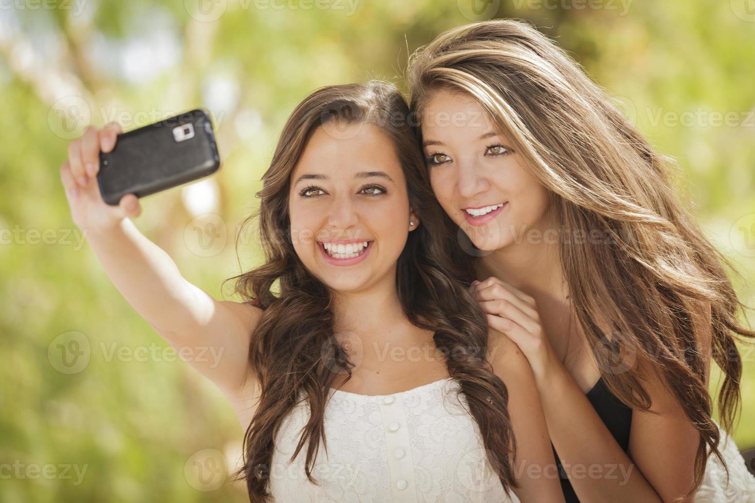 Attractive Mixed Race Girlfriends Taking Self Portrait with Camera photo