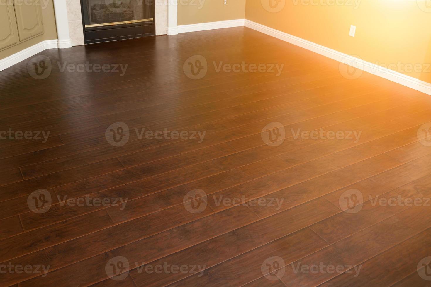 Newly Installed Brown Laminate Flooring and Baseboards in Home photo