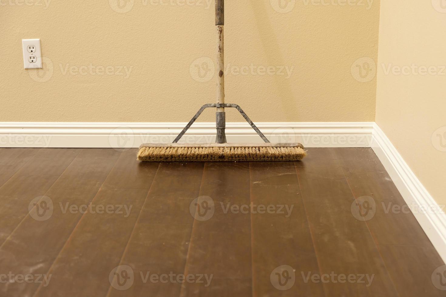 Push Broom on a Newly Installed Laminate Floor and Baseboard photo