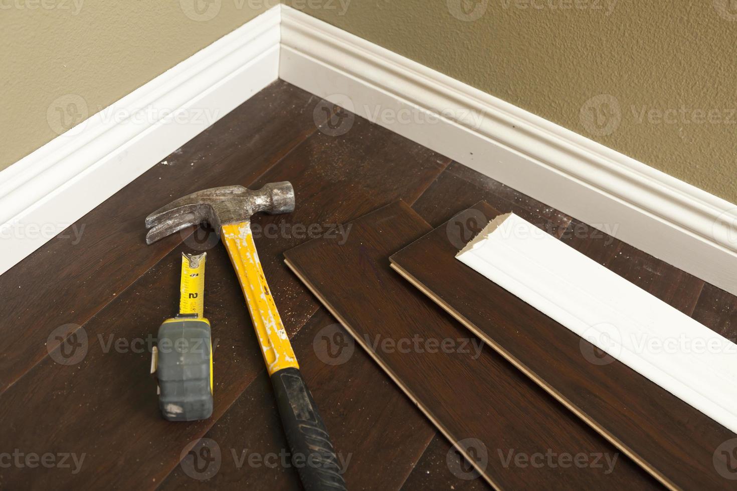 Hammer, Laminate Flooring and New Baseboard Molding 16356624 Stock Photo at Vecteezy