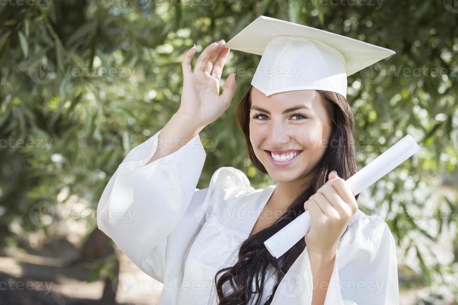 Graduating Mixed Race Girl In Cap and Gown with Diploma photo
