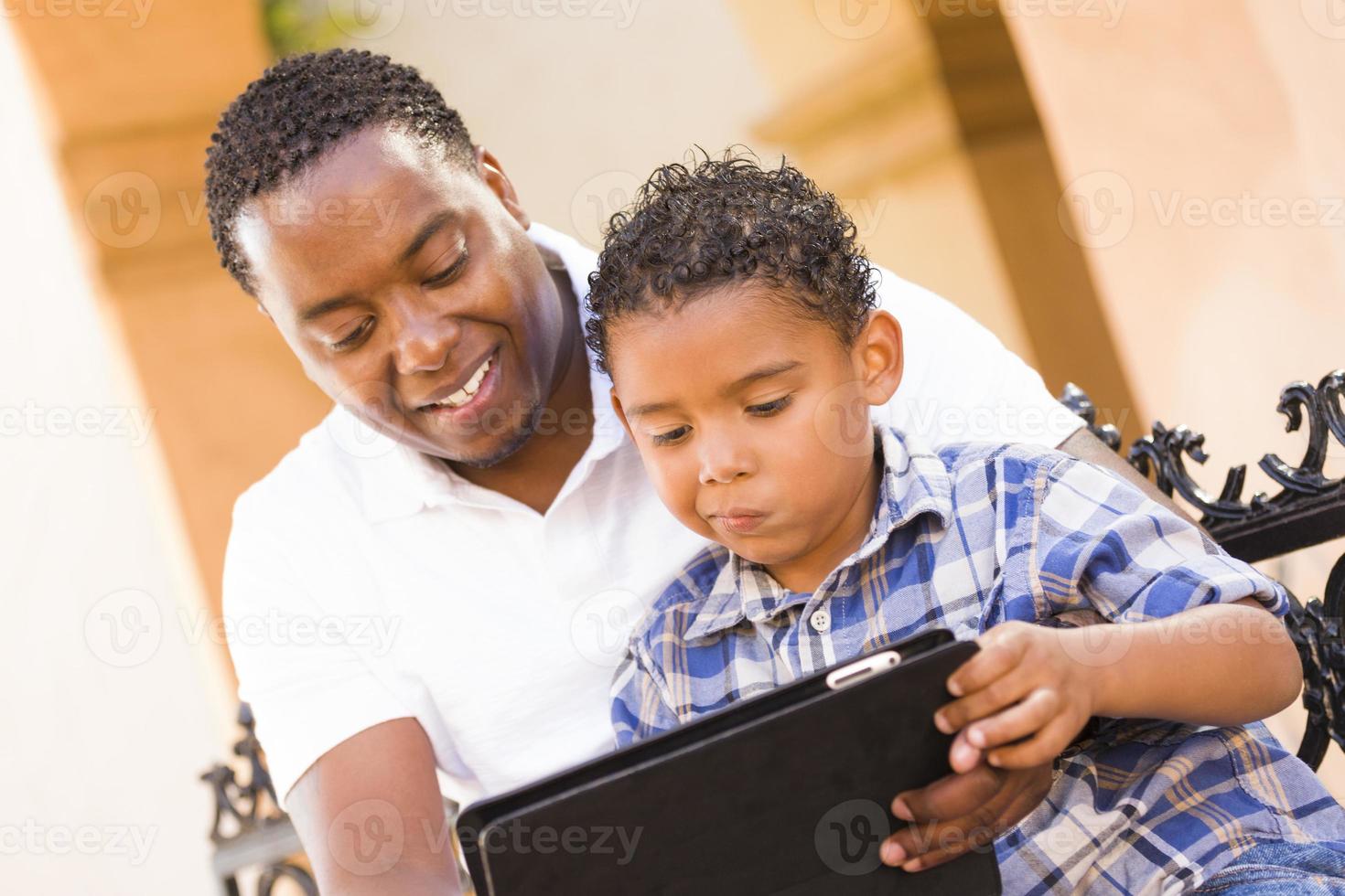 Mixed Race Father and Son Using Touch Pad Computer Tablet photo
