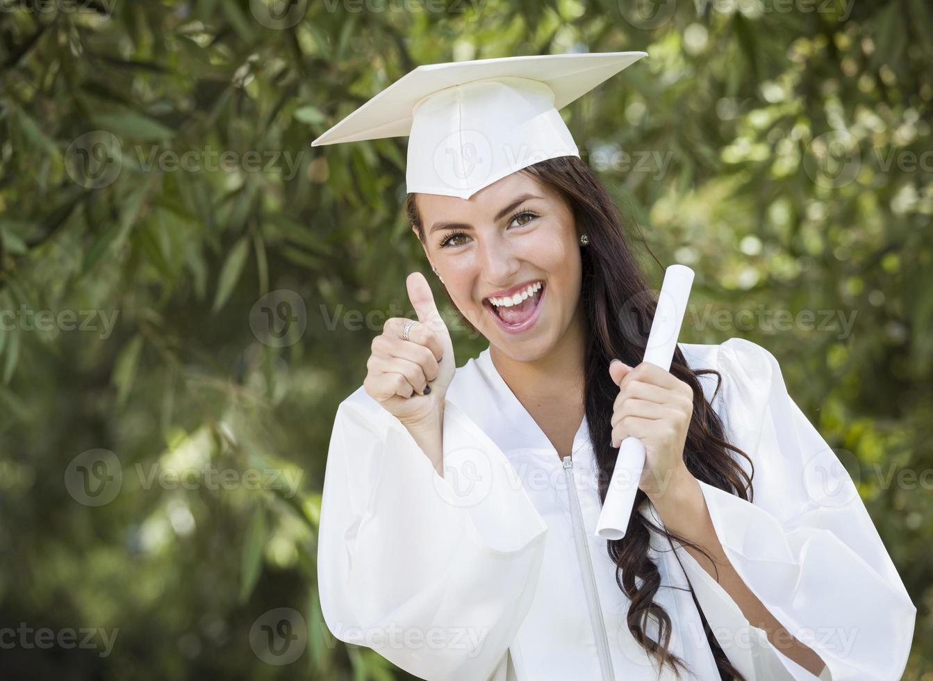 Graduating Mixed Race Girl In Cap and Gown with Diploma photo