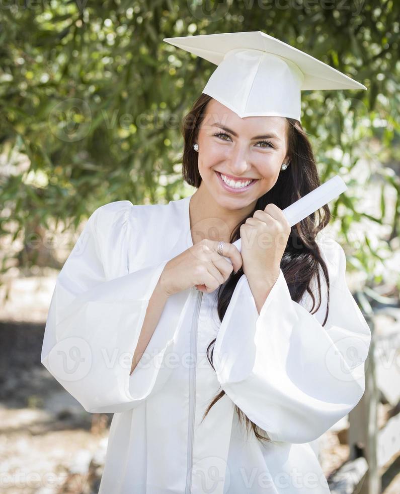 Graduating Mixed Race Girl In Cap and Gown with Diploma photo