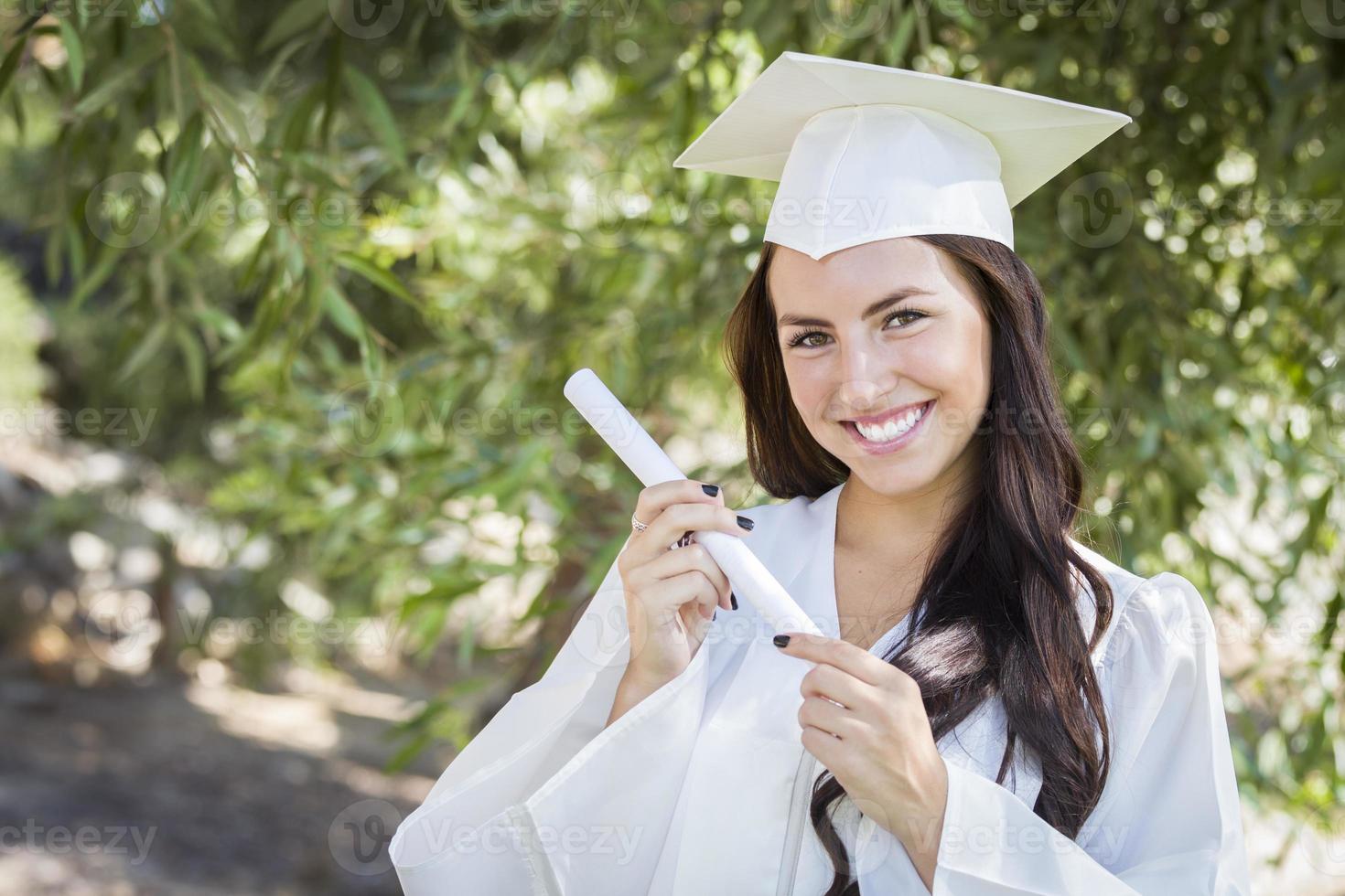 Graduating Mixed Race Girl In Cap and Gown with Diploma photo