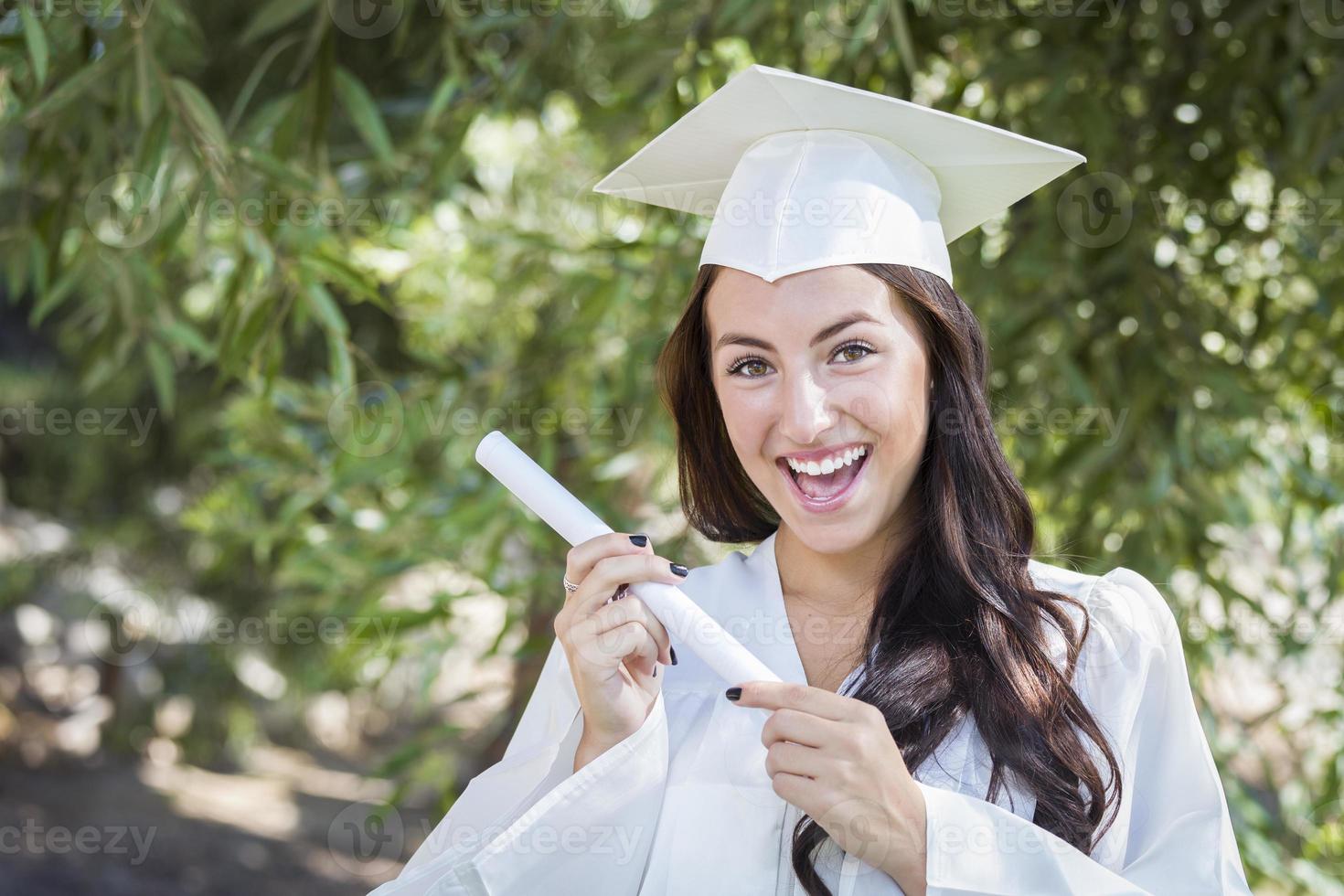 Graduating Mixed Race Girl In Cap and Gown with Diploma photo