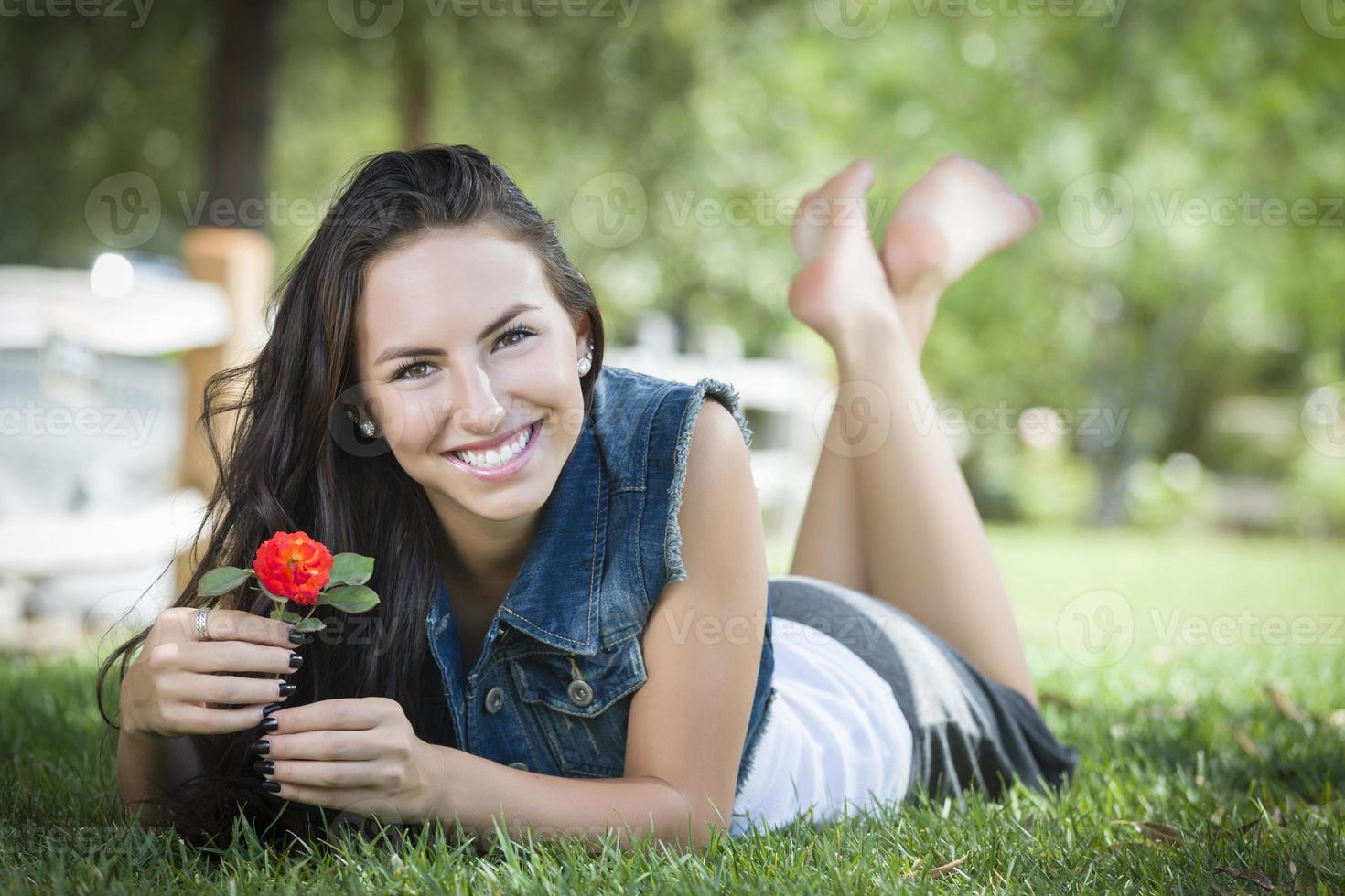 Attractive Mixed Race Girl Portrait Laying in Grass photo