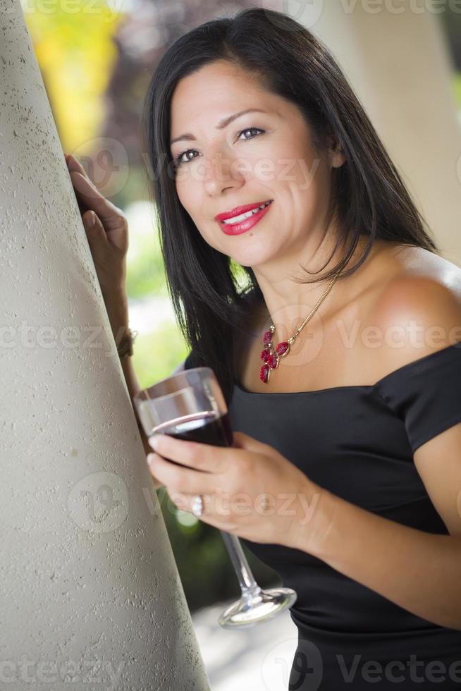 Attractive Hispanic Woman Portrait Outside Enjoying Wine photo