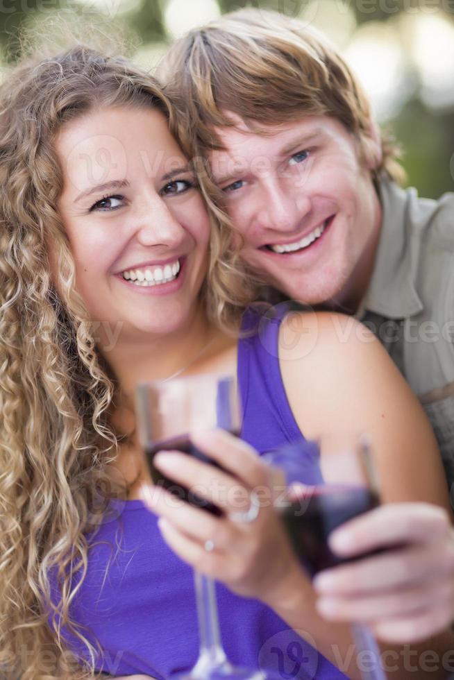 An Attractive Couple Enjoying A Glass Of Wine in the Park photo