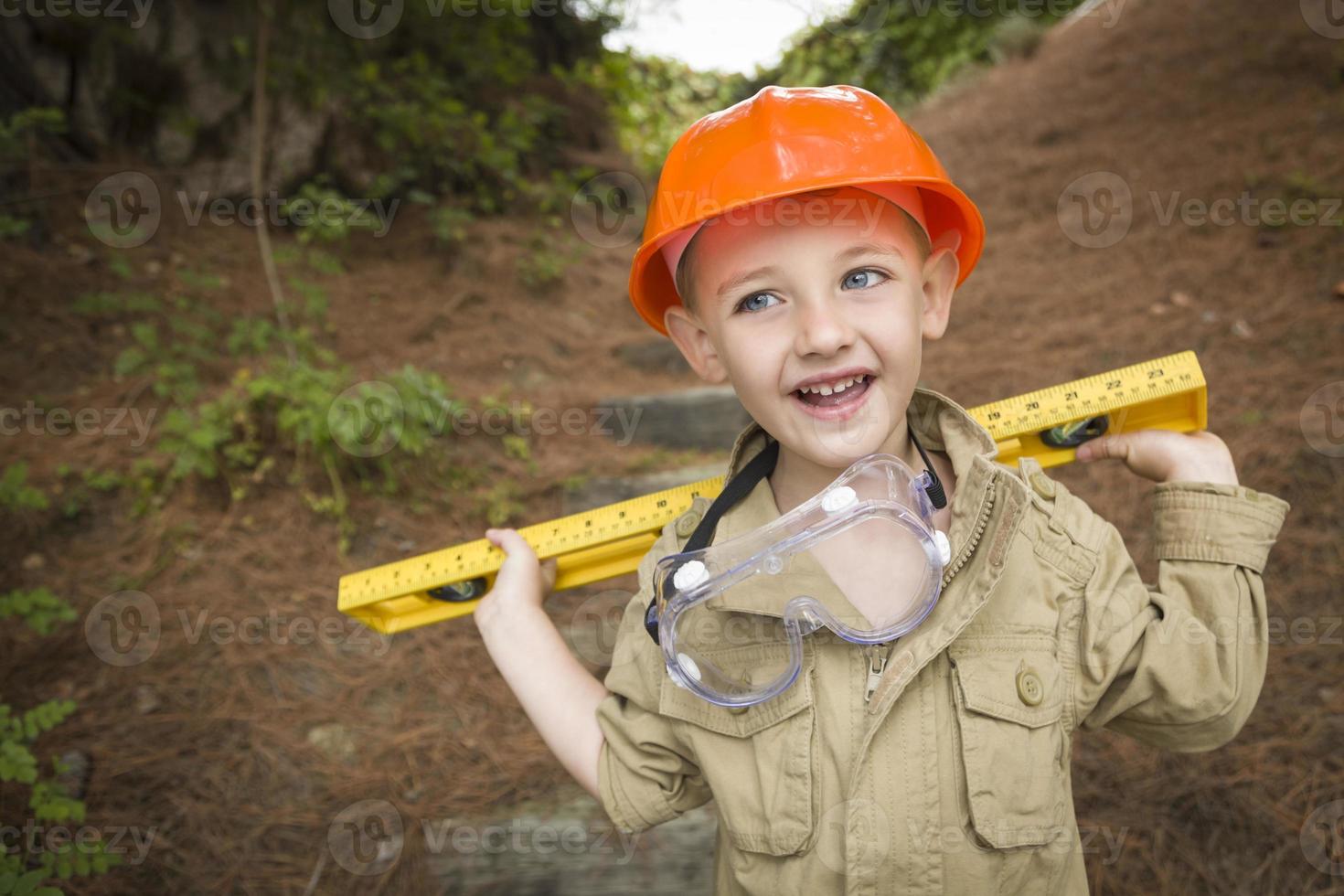 Adorable Child Boy with Level Playing Handyman Outside photo