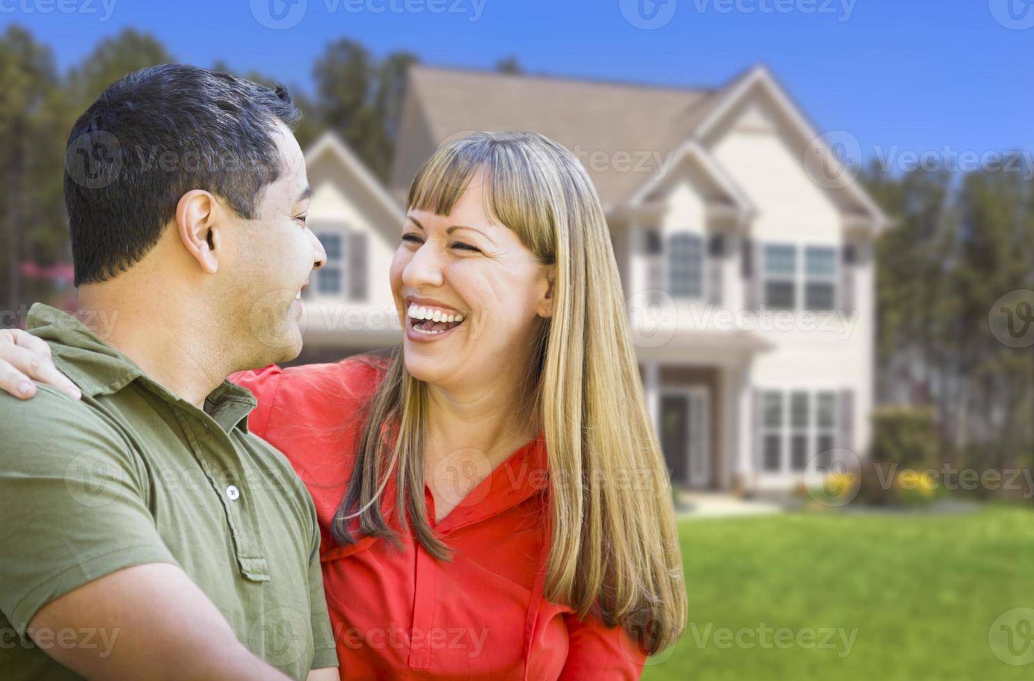 Happy Mixed Race Couple in Front of House photo