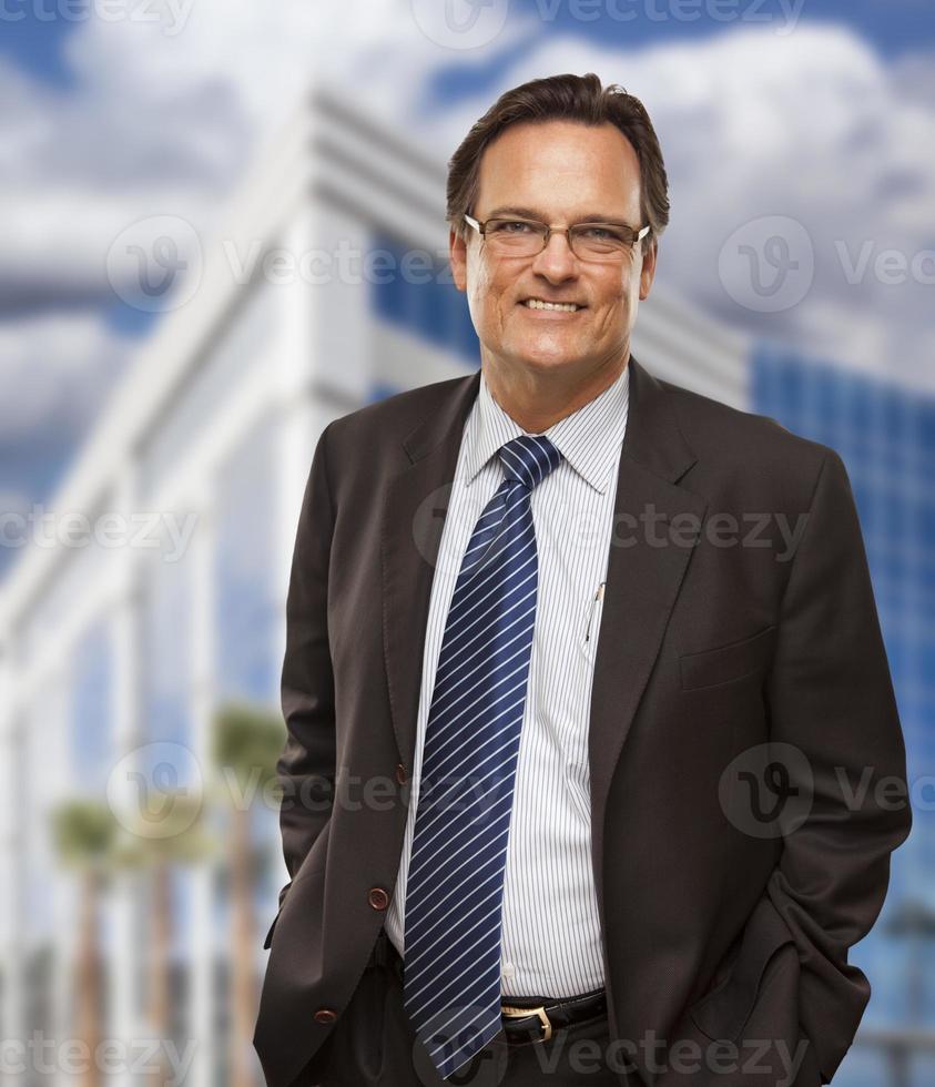 Handsome Businessman Smiling in Front of Building photo