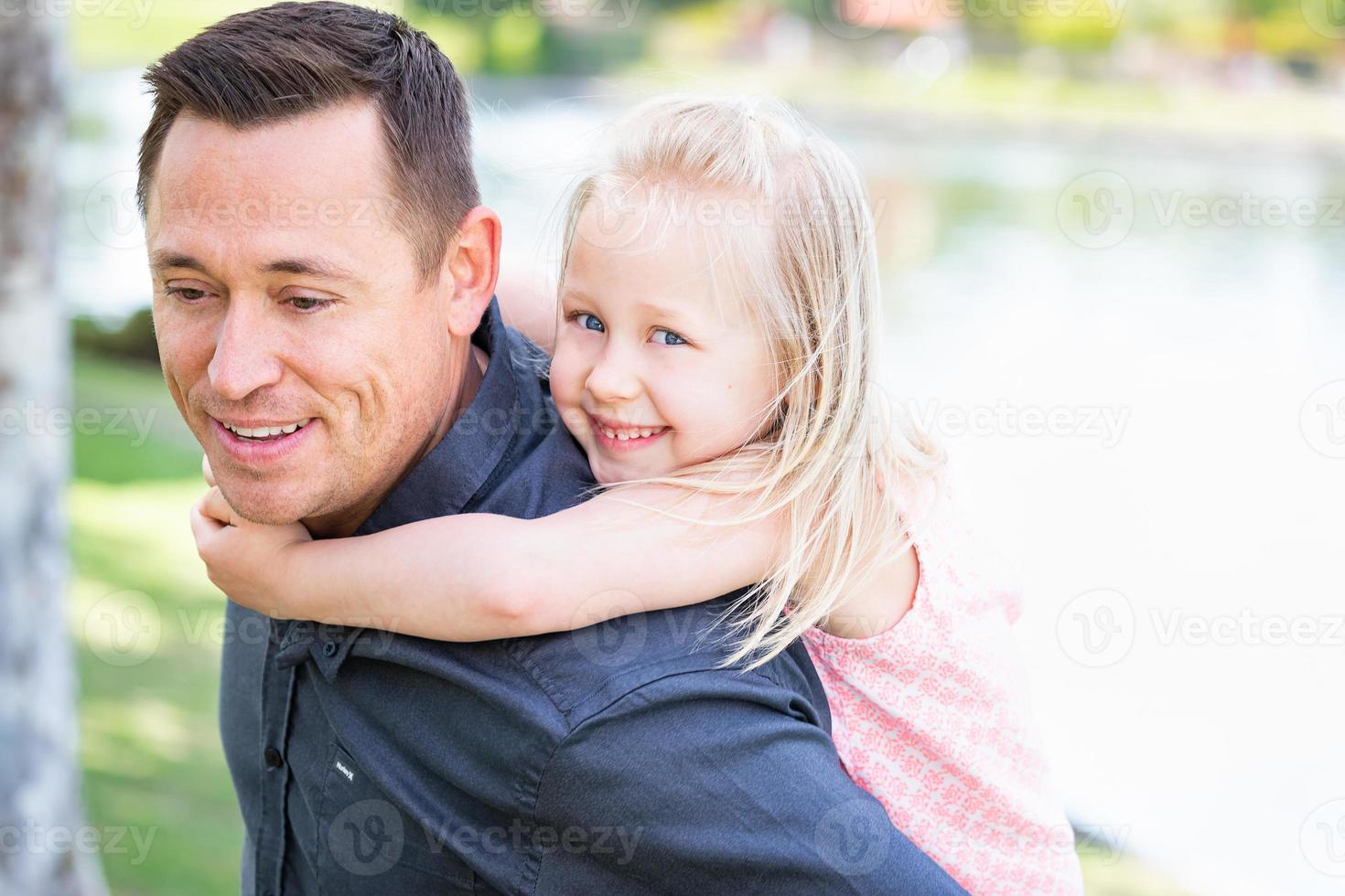 Young Caucasian Father and Daughter Having Fun At The Park photo