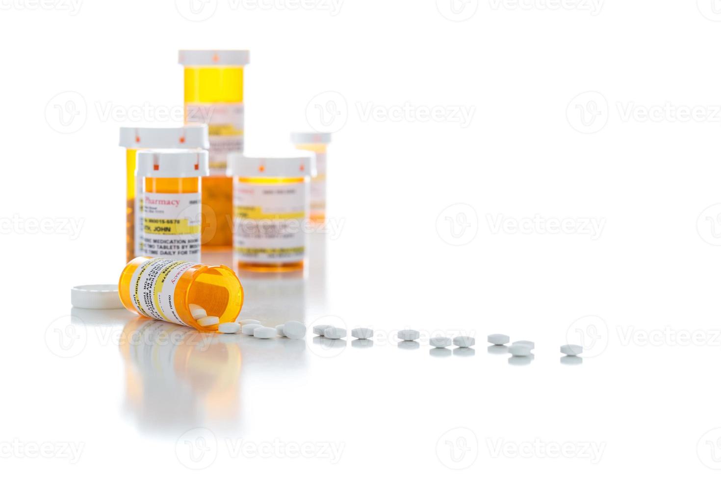 Non-Proprietary Medicine Prescription Bottles and Spilled Pills Isolated on White photo