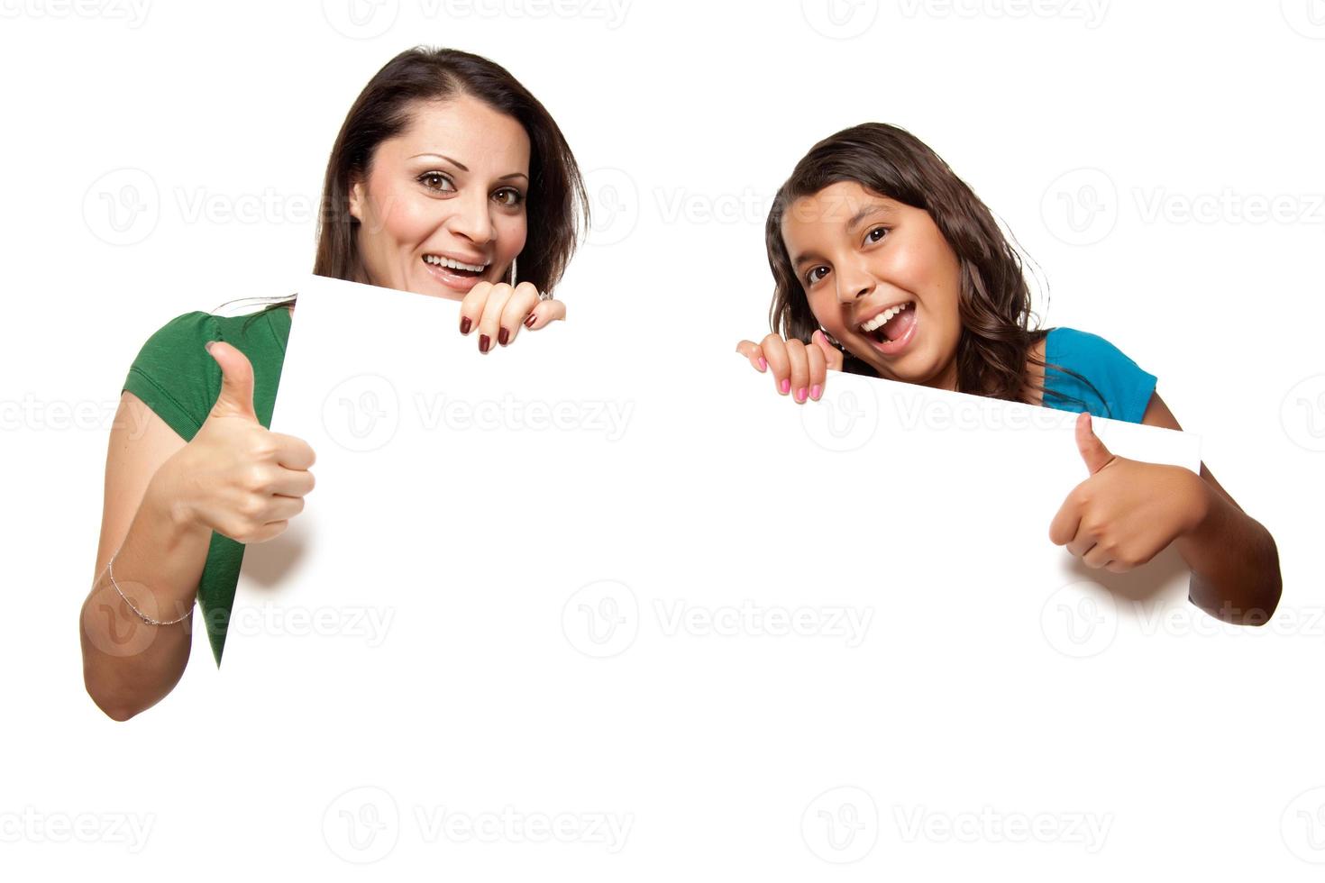 Pretty Hispanic Girl and Mother Holding Blank Board photo