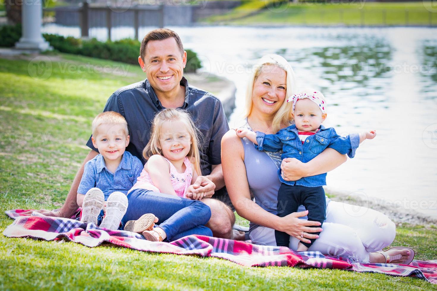 Happy Young Caucasian Family Portrait In The Park photo