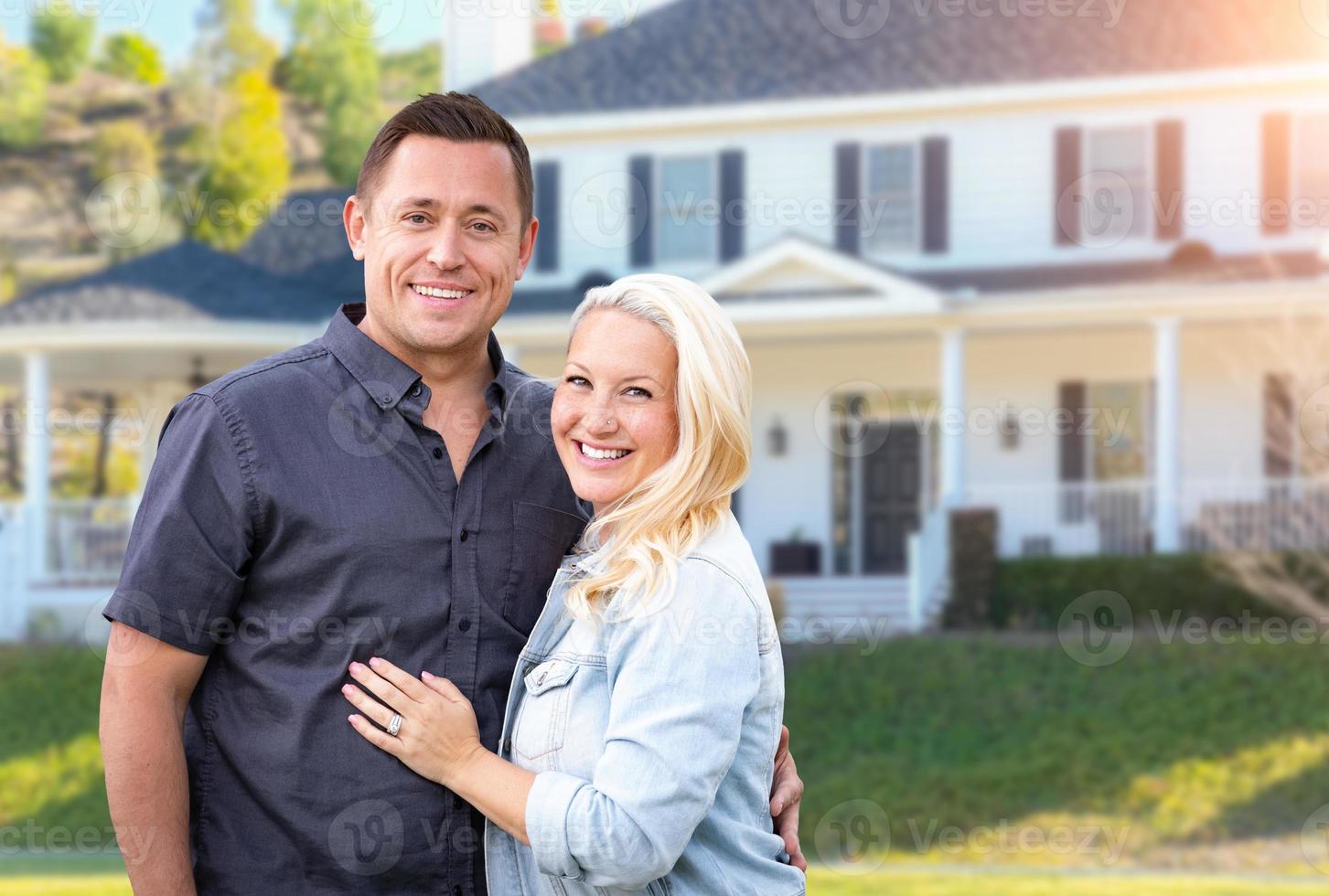 Happy Couple In Front of Beautiful House photo