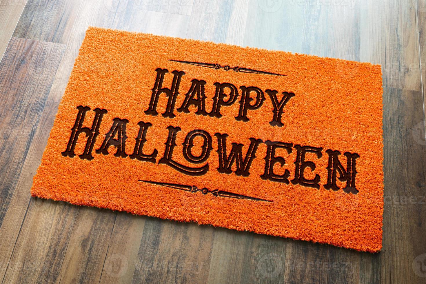 Happy Halloween Orange Welcome Mat On Wood Floor Background photo