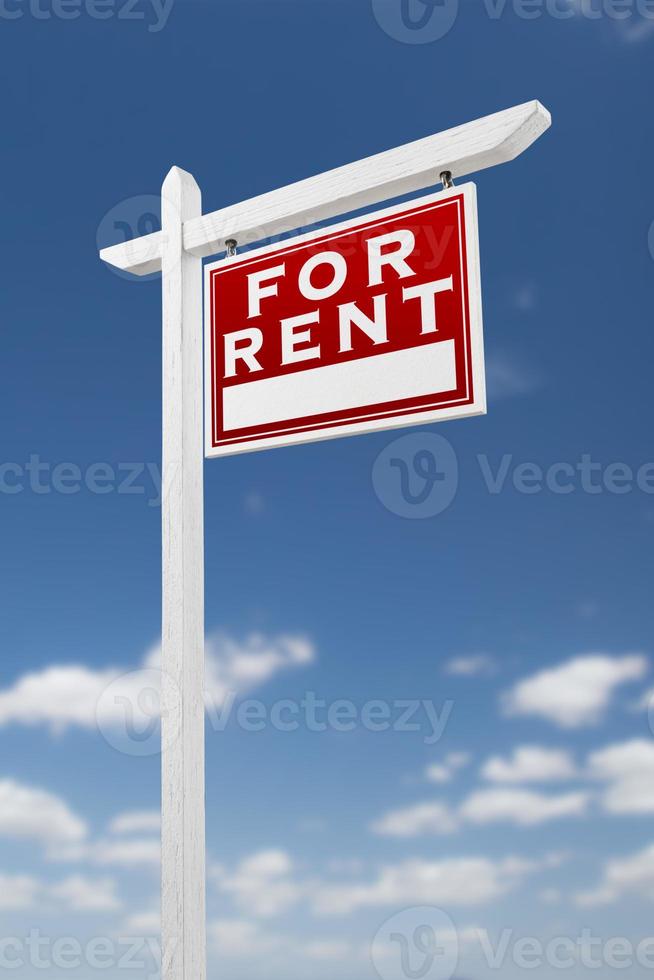 Right Facing For Rent Real Estate Sign on a Blue Sky with Clouds. photo