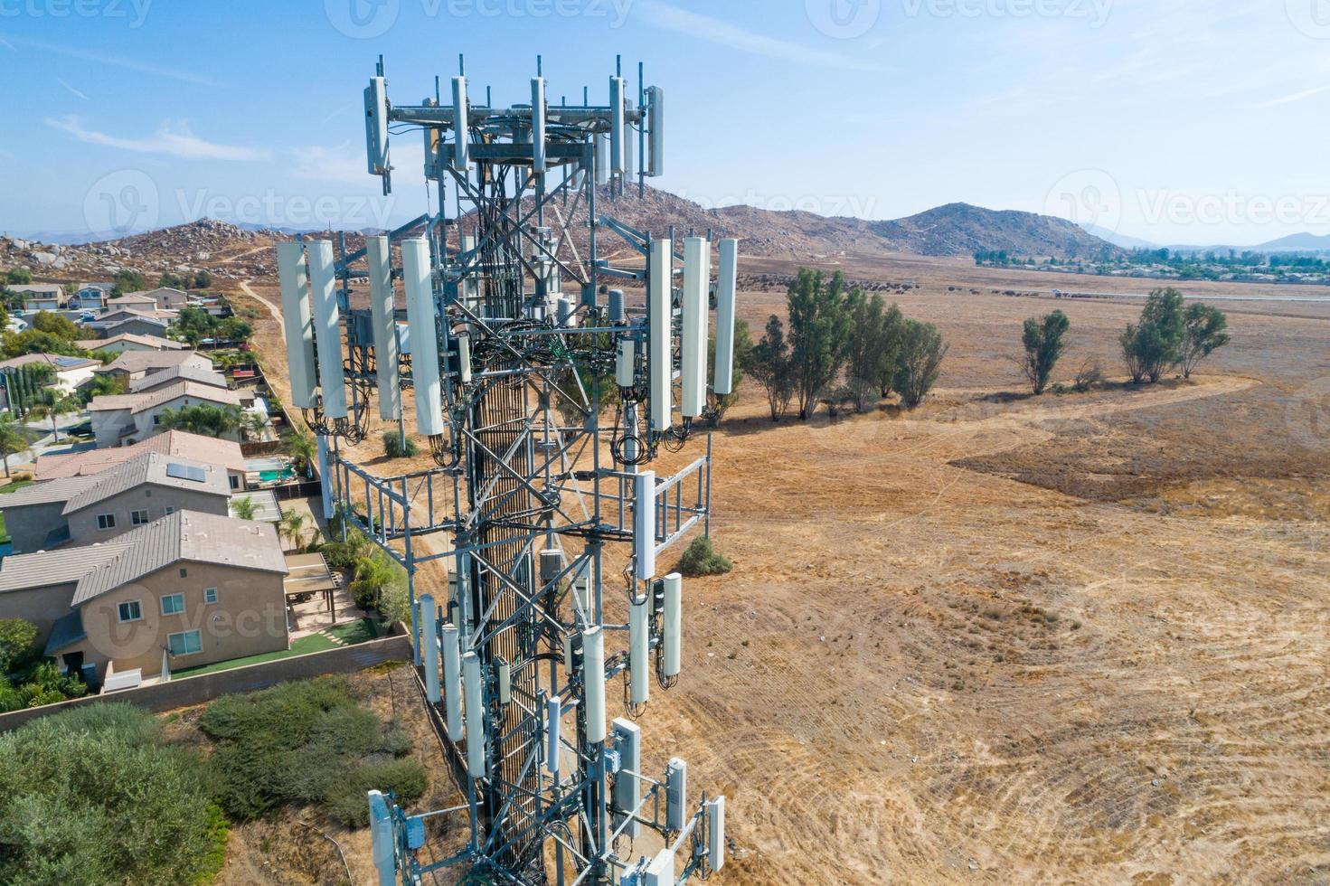 Close-up Aerial of Cellular Wireless Mobile Data Tower with Neighborhood Surrounding photo