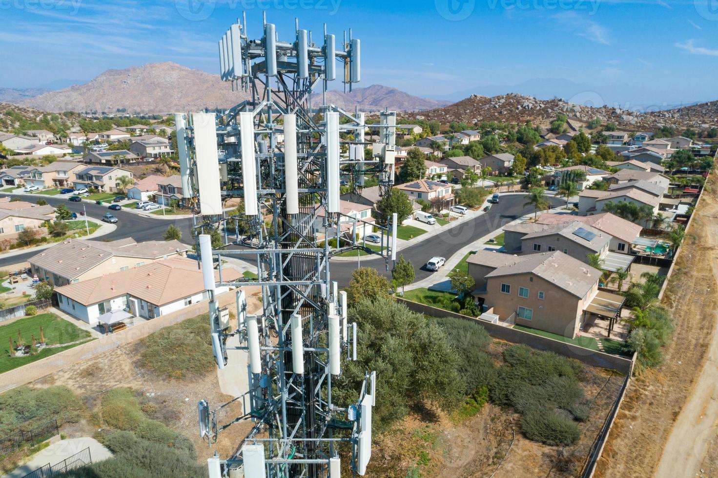 Close-up Aerial of Cellular Wireless Mobile Data Tower with Neighborhood Surrounding photo