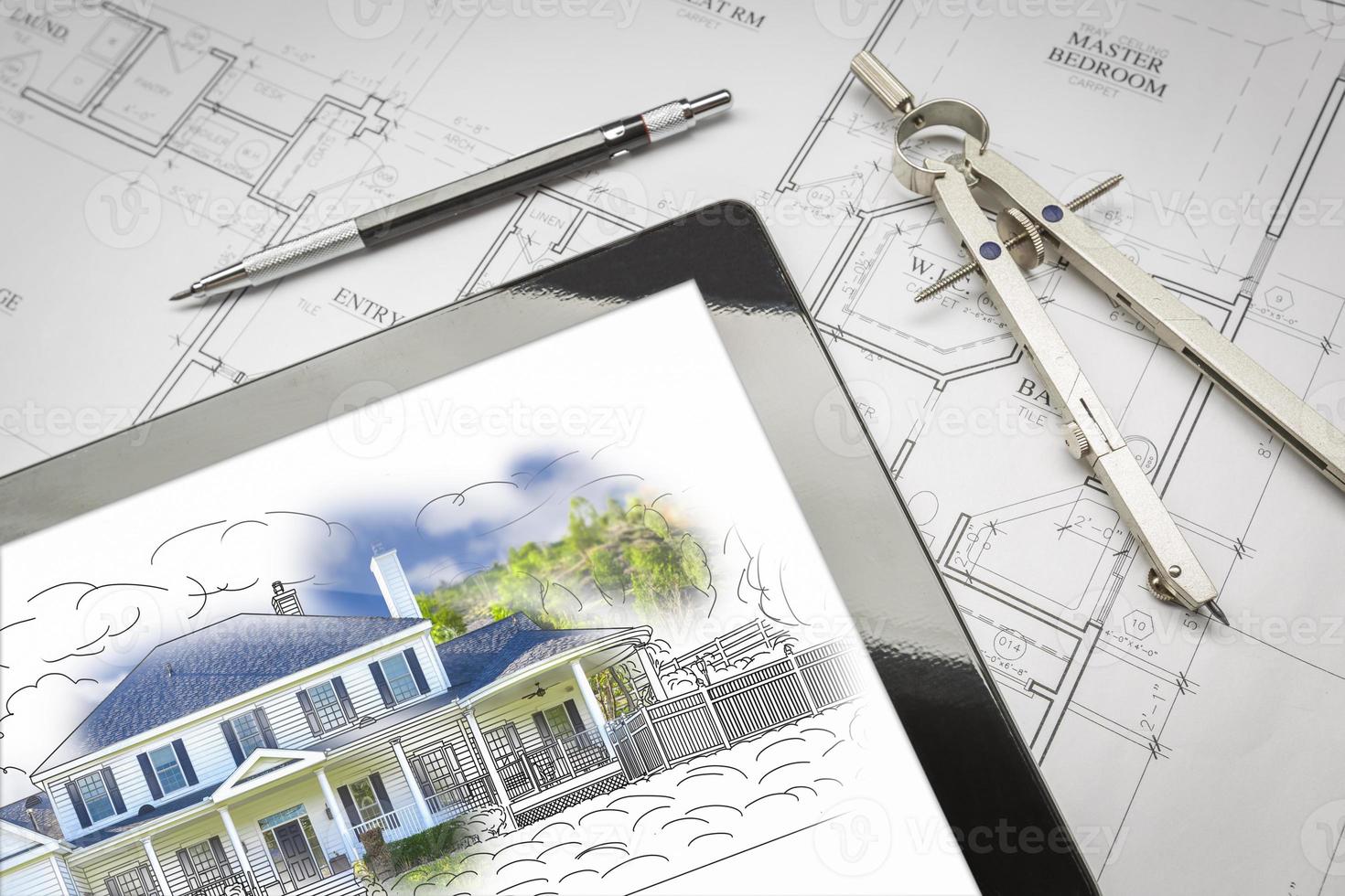 Computer Tablet Showing House Illustration On House Plans, Pencil, Compass photo