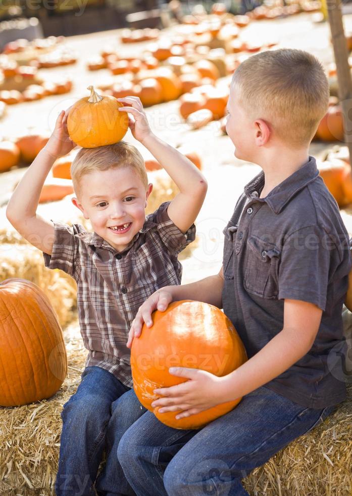 Two Boys at the Pumpkin Patch Talking and Having Fun photo