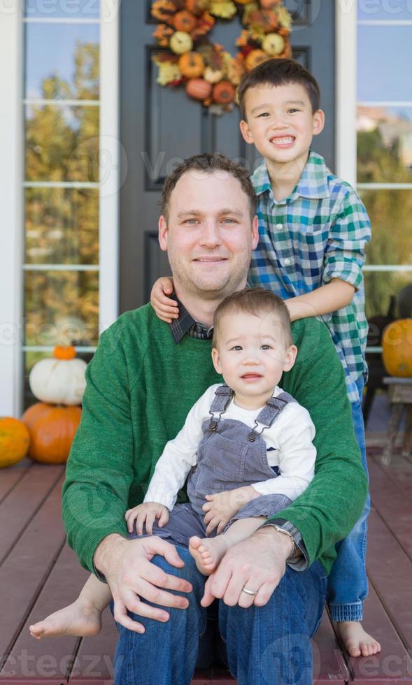 Young Mixed Race Chinese and Caucasian Father with His Sons photo