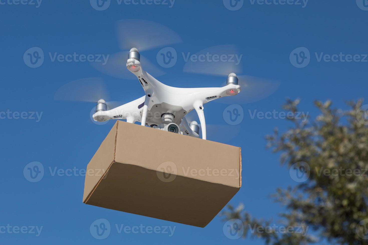 Unmanned Aircraft System UAV Quadcopter Drone Delivering Package photo